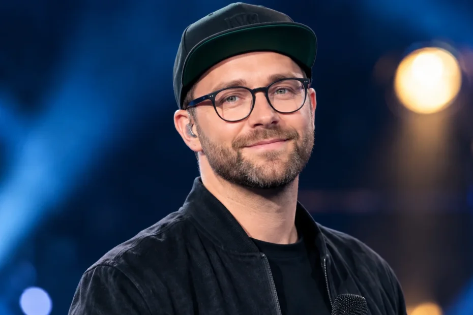 Mark Forster performing live on stage with a microphone